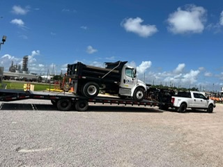 Dump truck hauled on a step-deck trailer