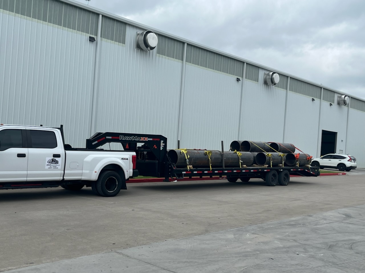 Steel pipe loaded on a LeadFoot Express flatbed at an industrial facility