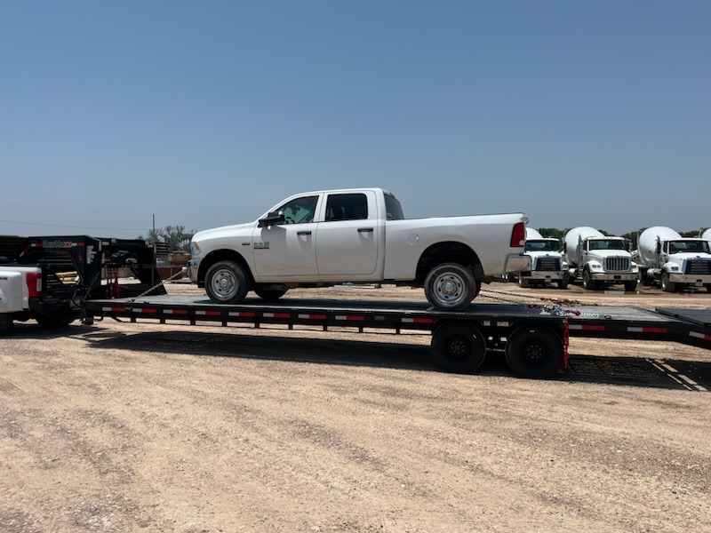 Pickup truck chained down on a LeadFoot Express gooseneck trailer
